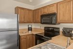 The kitchen is compact yet well-appointed with modern appliances and amenities